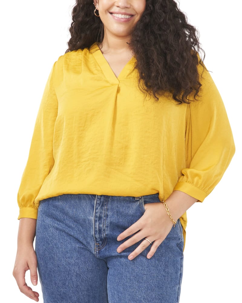 Front of a model wearing a size 1X Everley V-Neck Blouse in Mosaic Mustard by Vince Camuto. | dia_product_style_image_id:261200